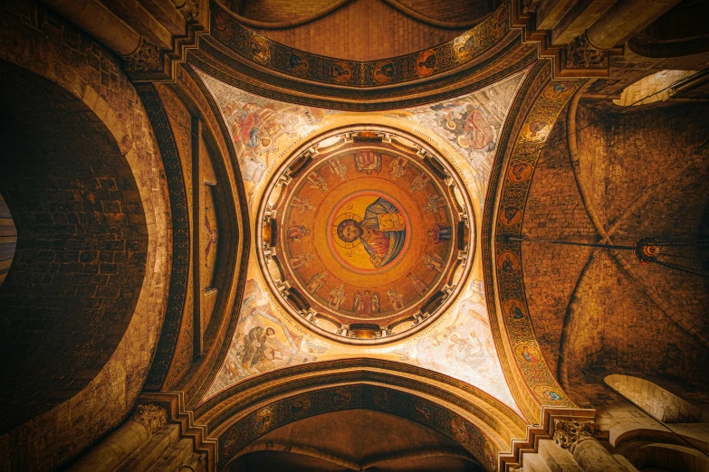 a ceiling in a building with a clock mounted to the side of it