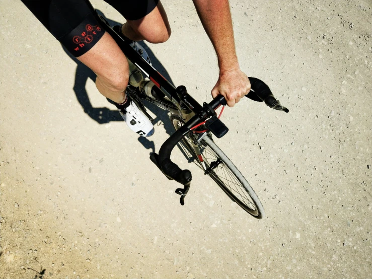 a person rides a bicycle on a concrete surface