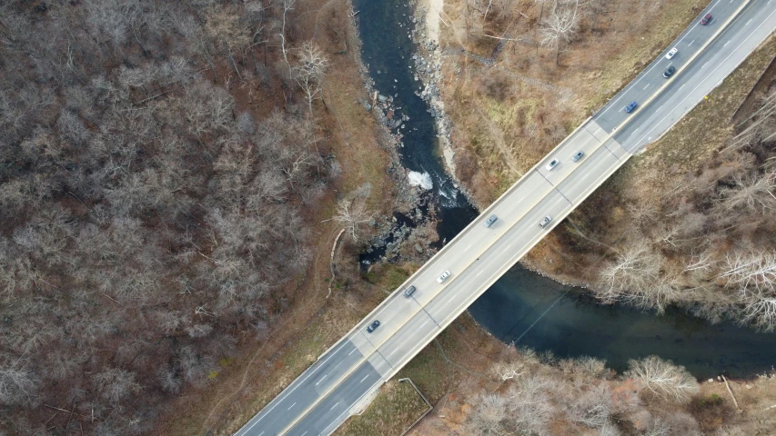 an aerial s shows a narrow road crossing over a bridge