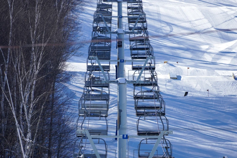 a ski lift filled with lots of people in the snow