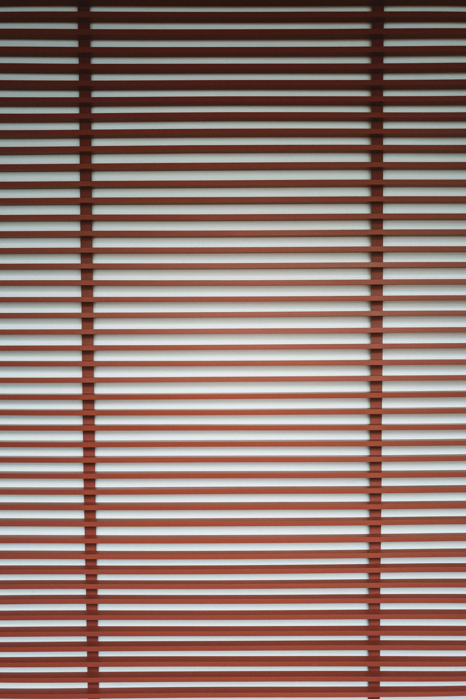 an image of shadows on a window that has blinds