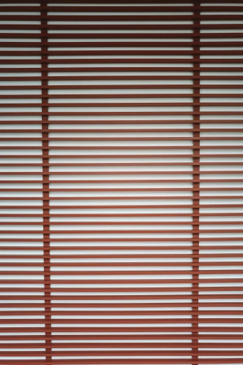 an image of shadows on a window that has blinds