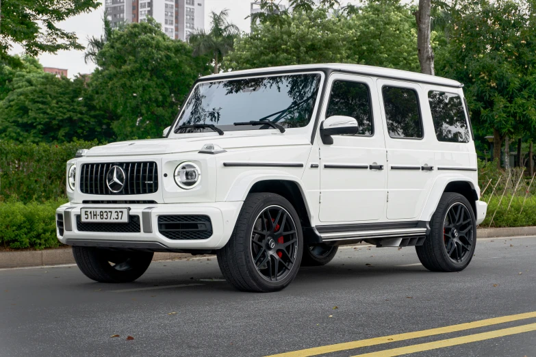 a mercedes benz g class suv is parked in a street