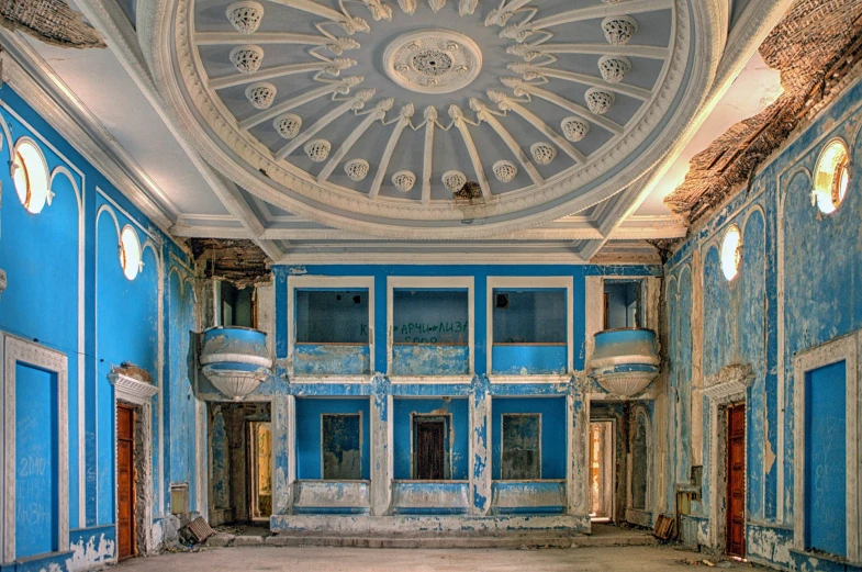 an abandoned building with large, blue walls and floors