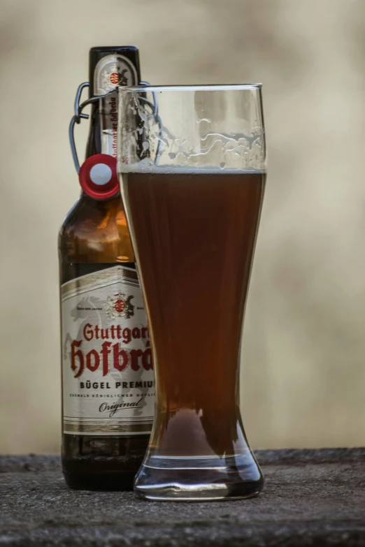 a bottle of beer next to a glass full of beer