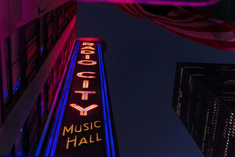 a building with neon lights is seen at night