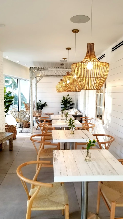 an outdoor patio with wooden chairs and tables