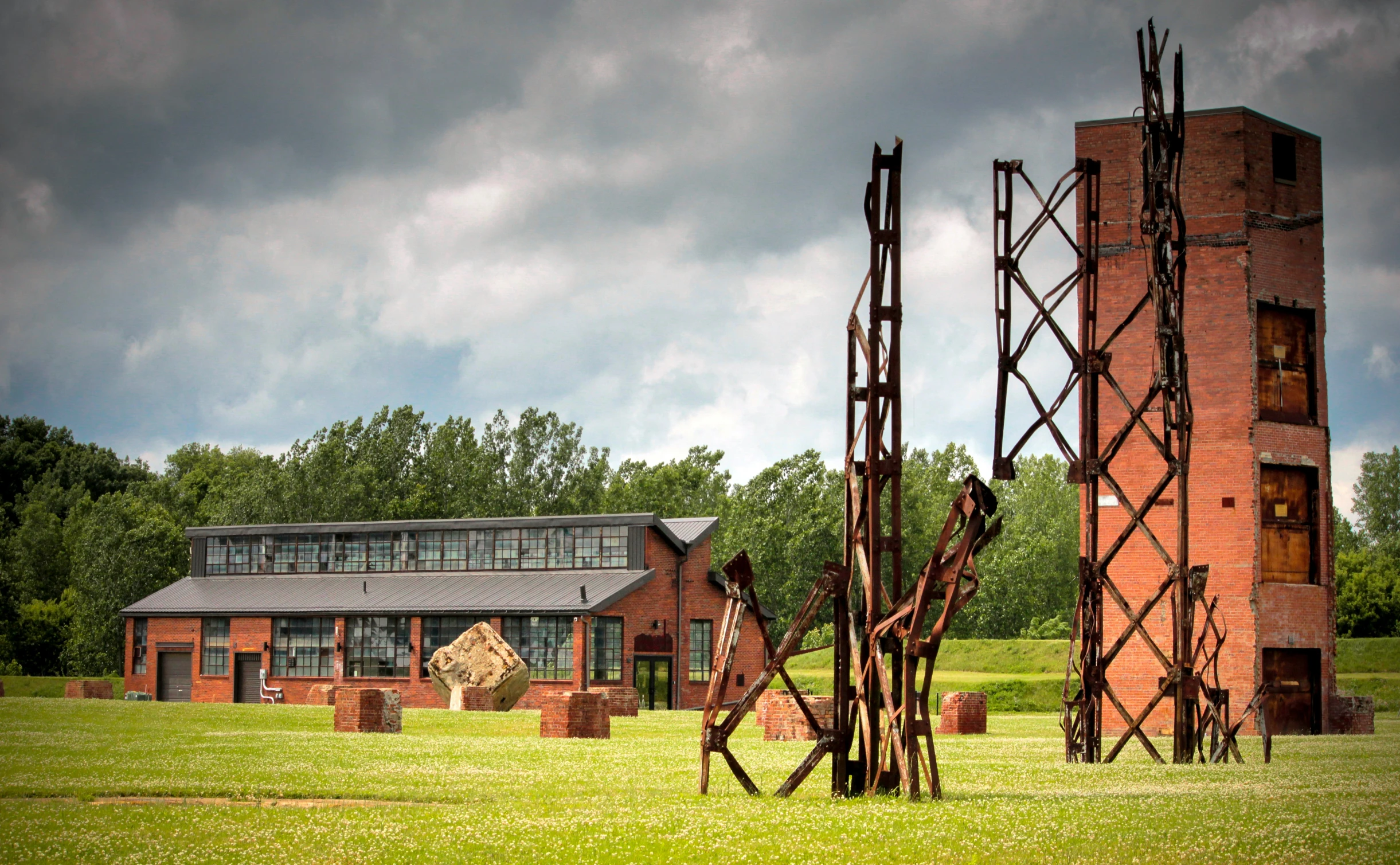 sculpture of multiple objects in front of building outdoors