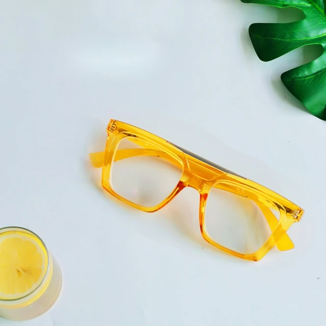 yellow glasses sitting on top of a white table