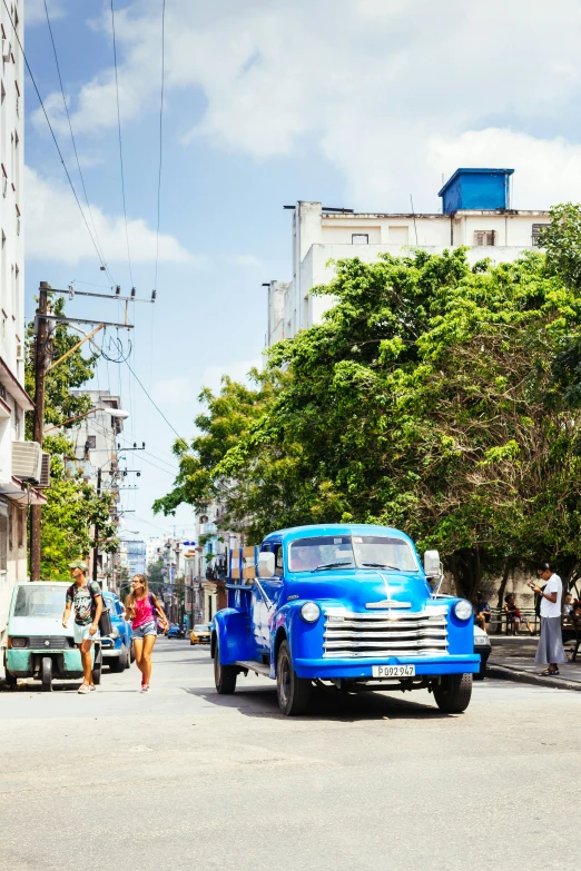 people walking on the street in front of old style buildings