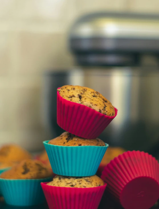 three muffins in pink and blue paper muffin cases