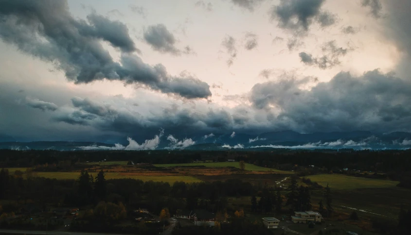 clouds are billowing in the sky during a sunset