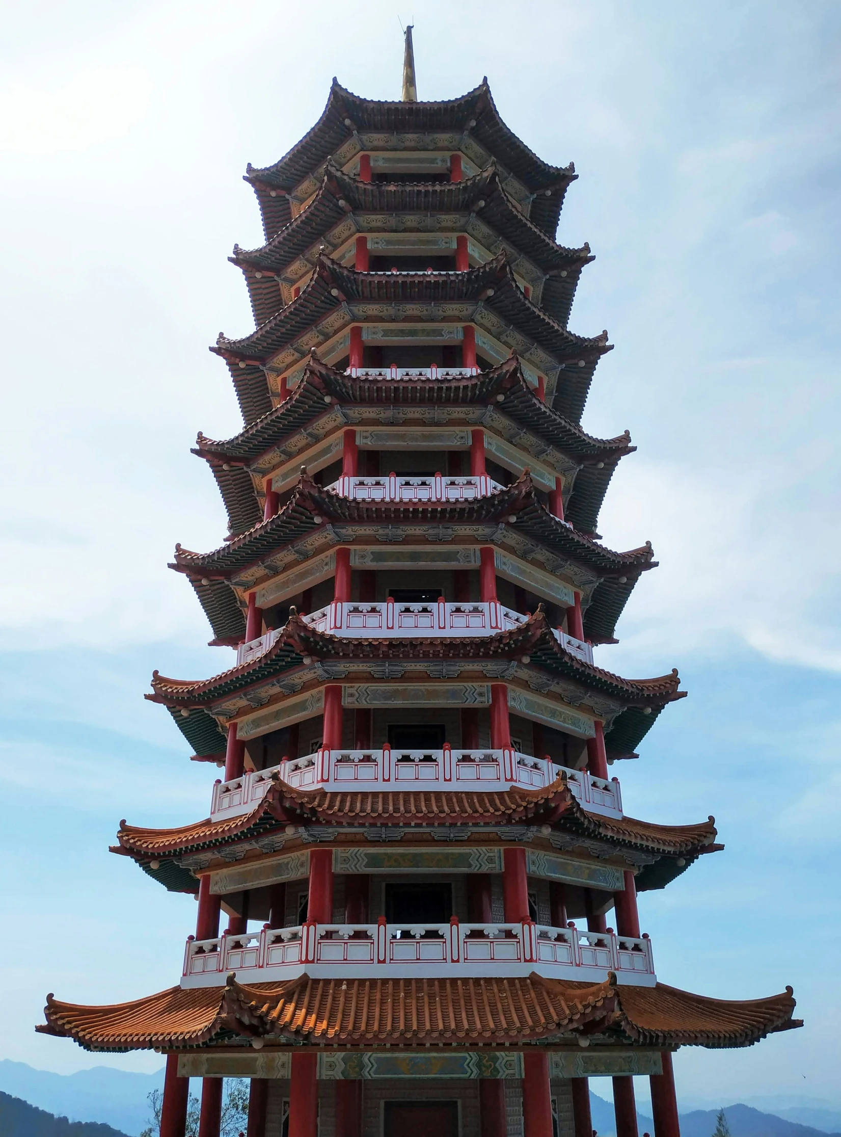 a red tall tower with lots of pillars