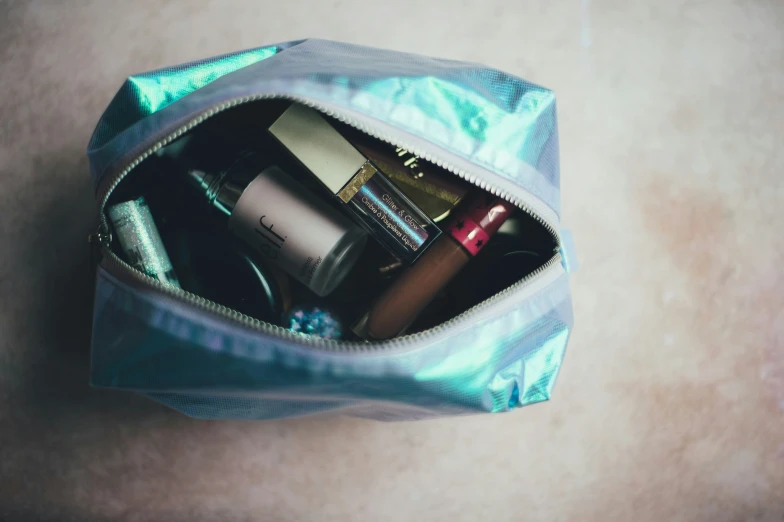 a purse with makeup and personal care items inside