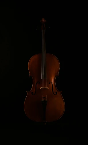a violin sitting in the dark and lit up