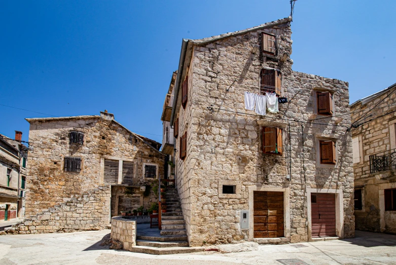 there is an old stone house with stairs leading up to it