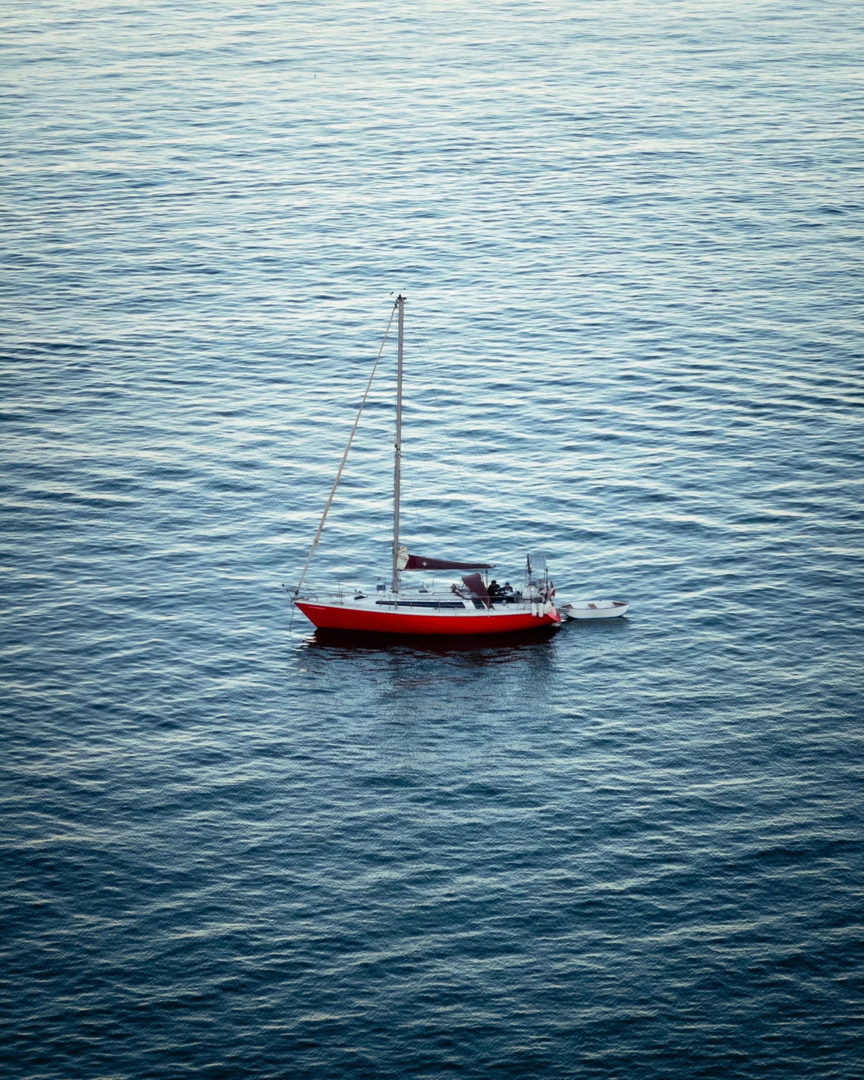 a sailboat floating in the middle of a body of water