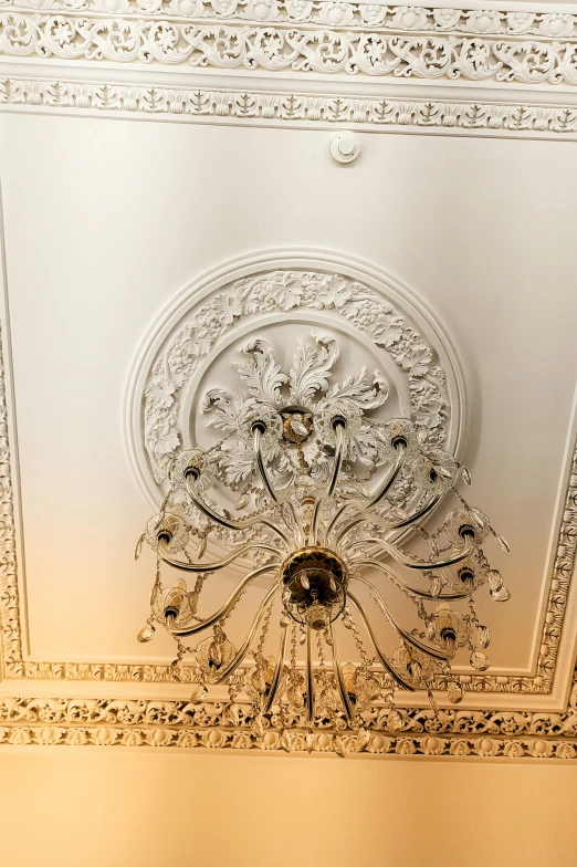 a white ceiling in a room with a fancy light fixture