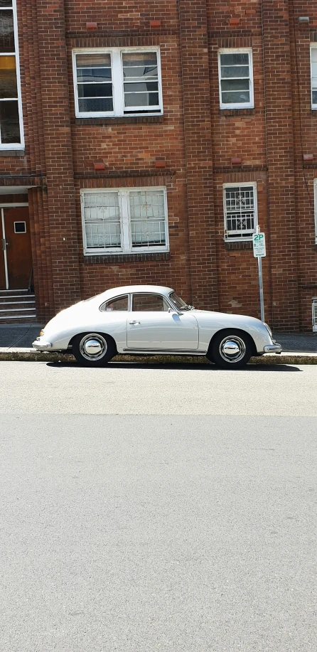 there is an old fashioned car parked on the side of the road