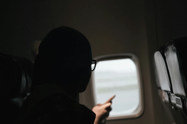 a person looking out a window while traveling