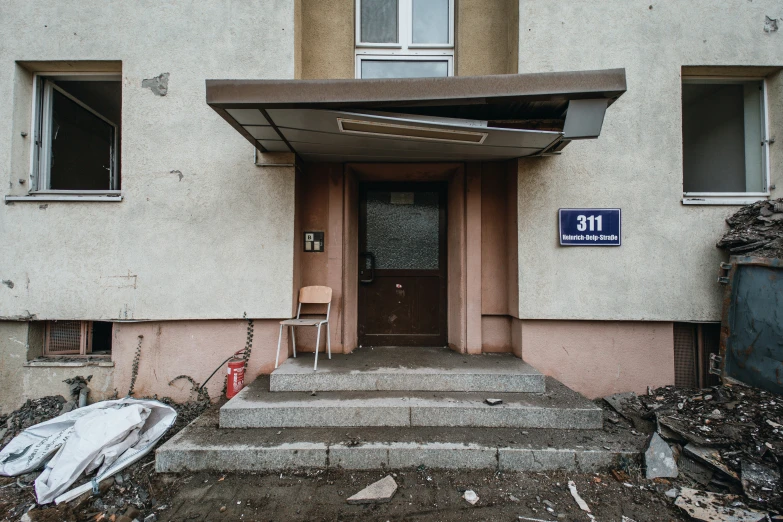 a set of steps to a door and a sign