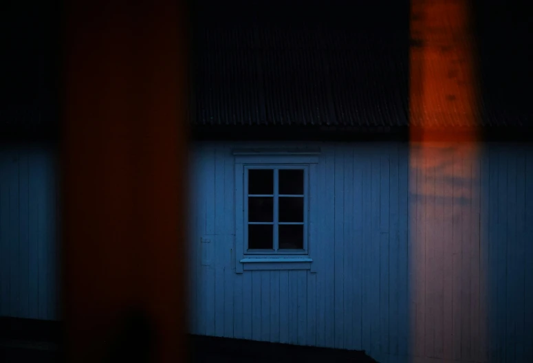 a room with a wooden window and blue walls