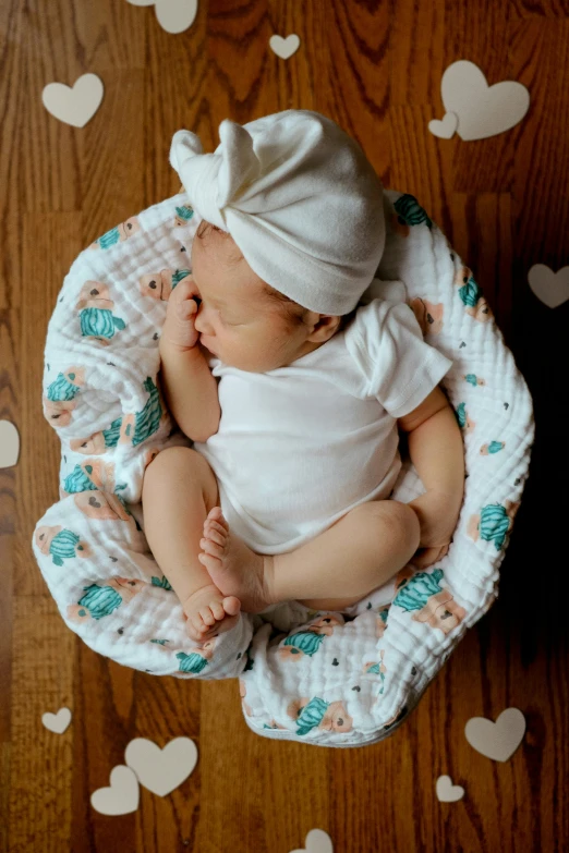 a small baby sitting in a nest in a room