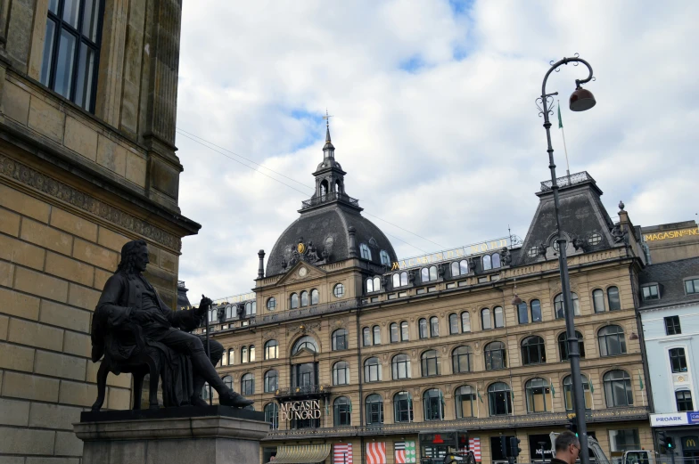 a statue and old building at the center of town