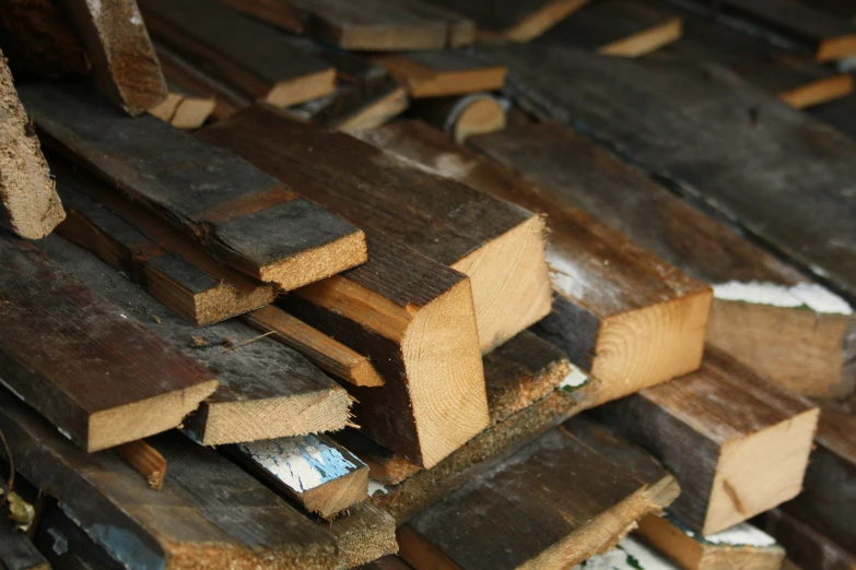 some wood planks piled up together on a floor