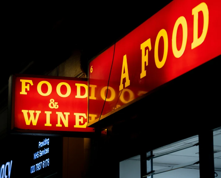 a neon sign is lit up by the night time