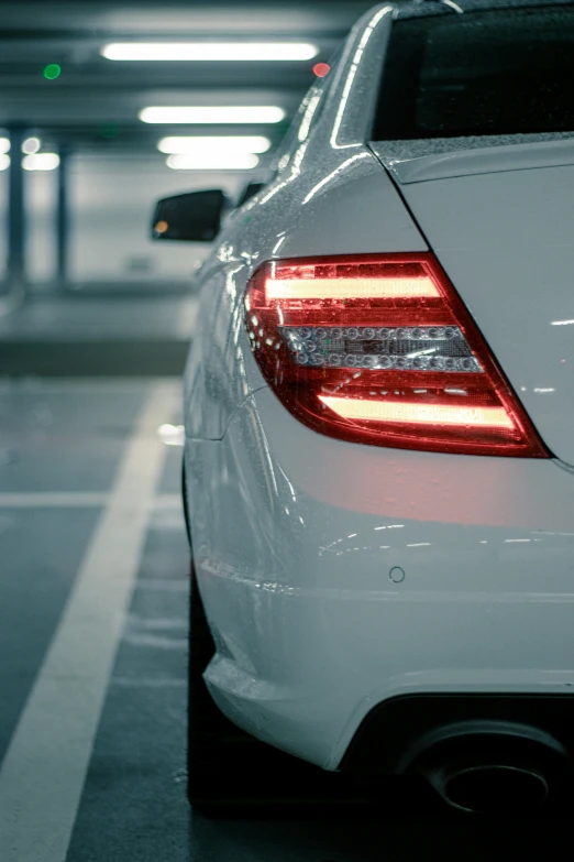 the tail lights of a white mercedes s class sedan