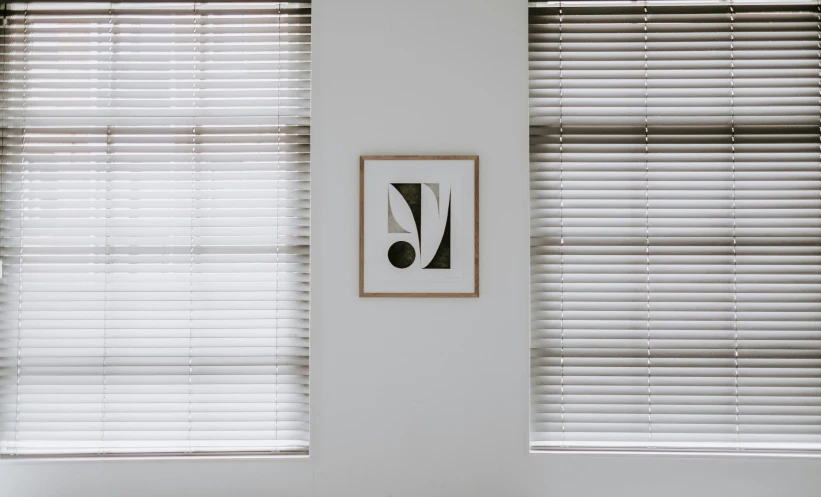 the blinds in this room are open with sunlight streaming through them