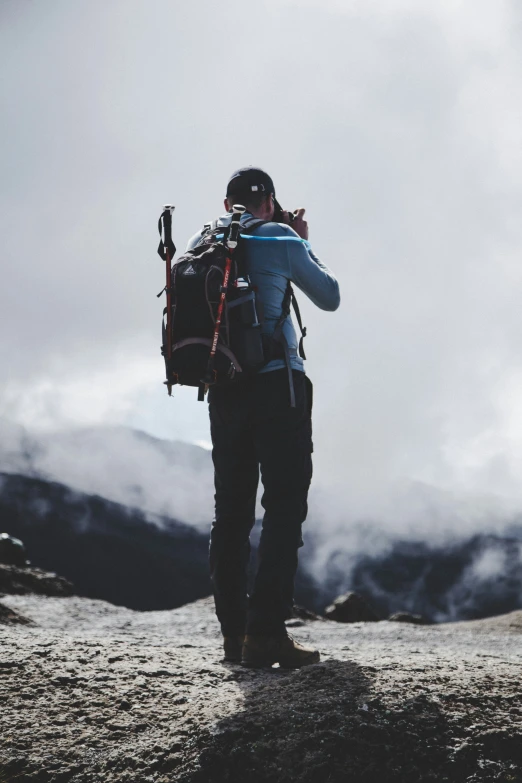 a person taking a picture on a mountain with a camera