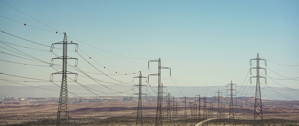 high voltage lines lead to the distant horizon