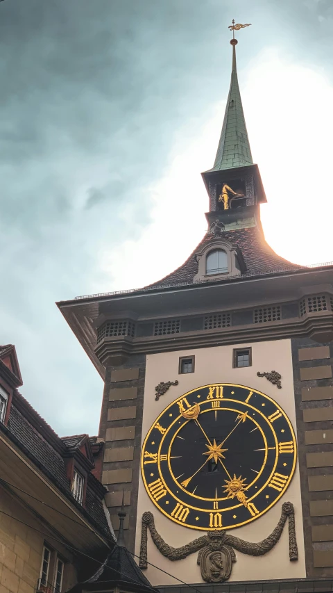 a clock tower that has a weather vein on it