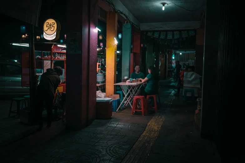 a dark restaurant with many people sitting at tables