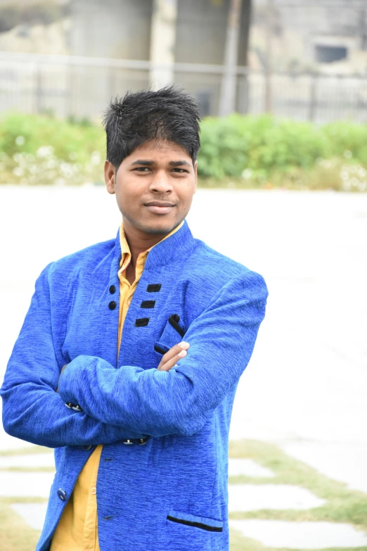 young indian man in blue blazer posing for pograph