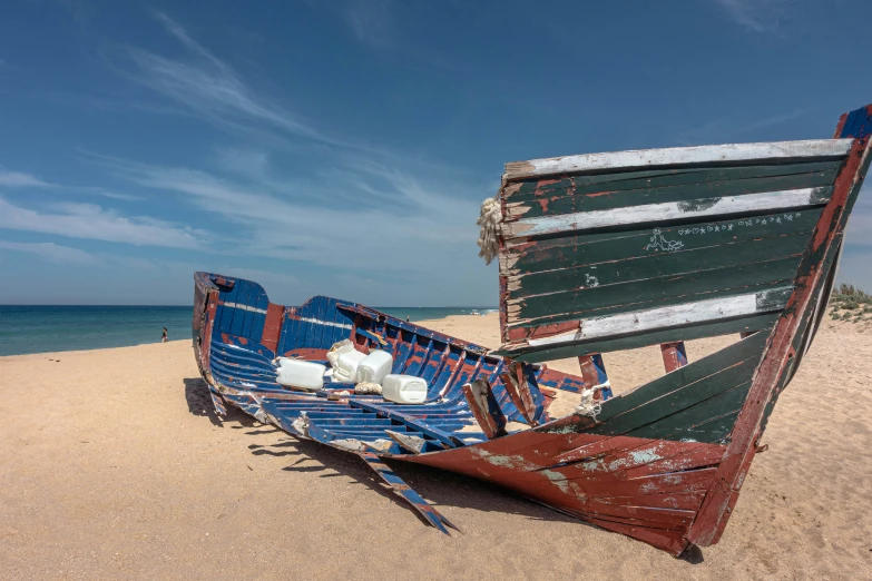 a boat that is sitting on the sand