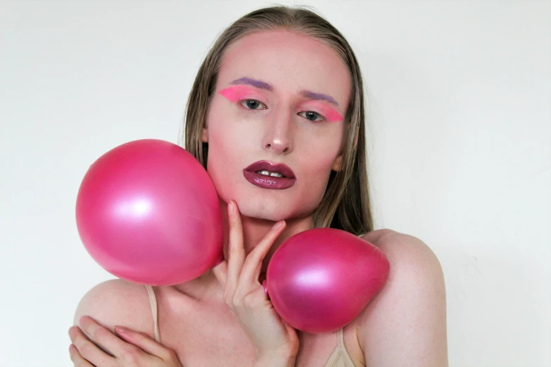 a woman poses with balloons like her hair