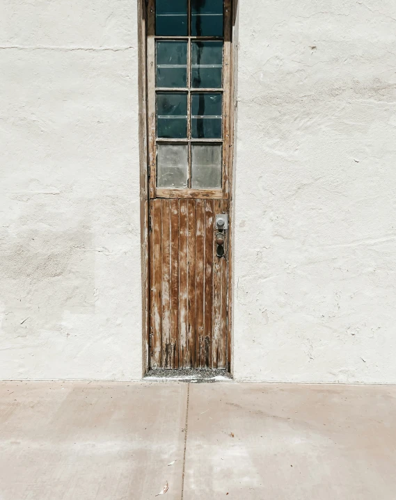 a wooden door is in between two stone buildings