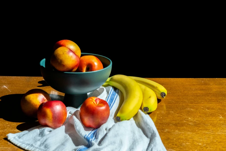 a wooden table topped with bananas and apples