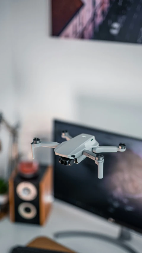 a remote control flies in front of a monitor