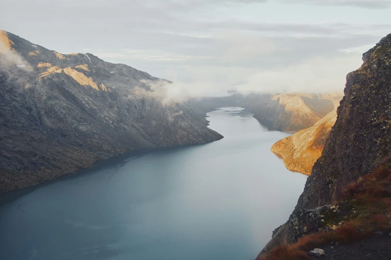 an aerial view of a large lake on mountains