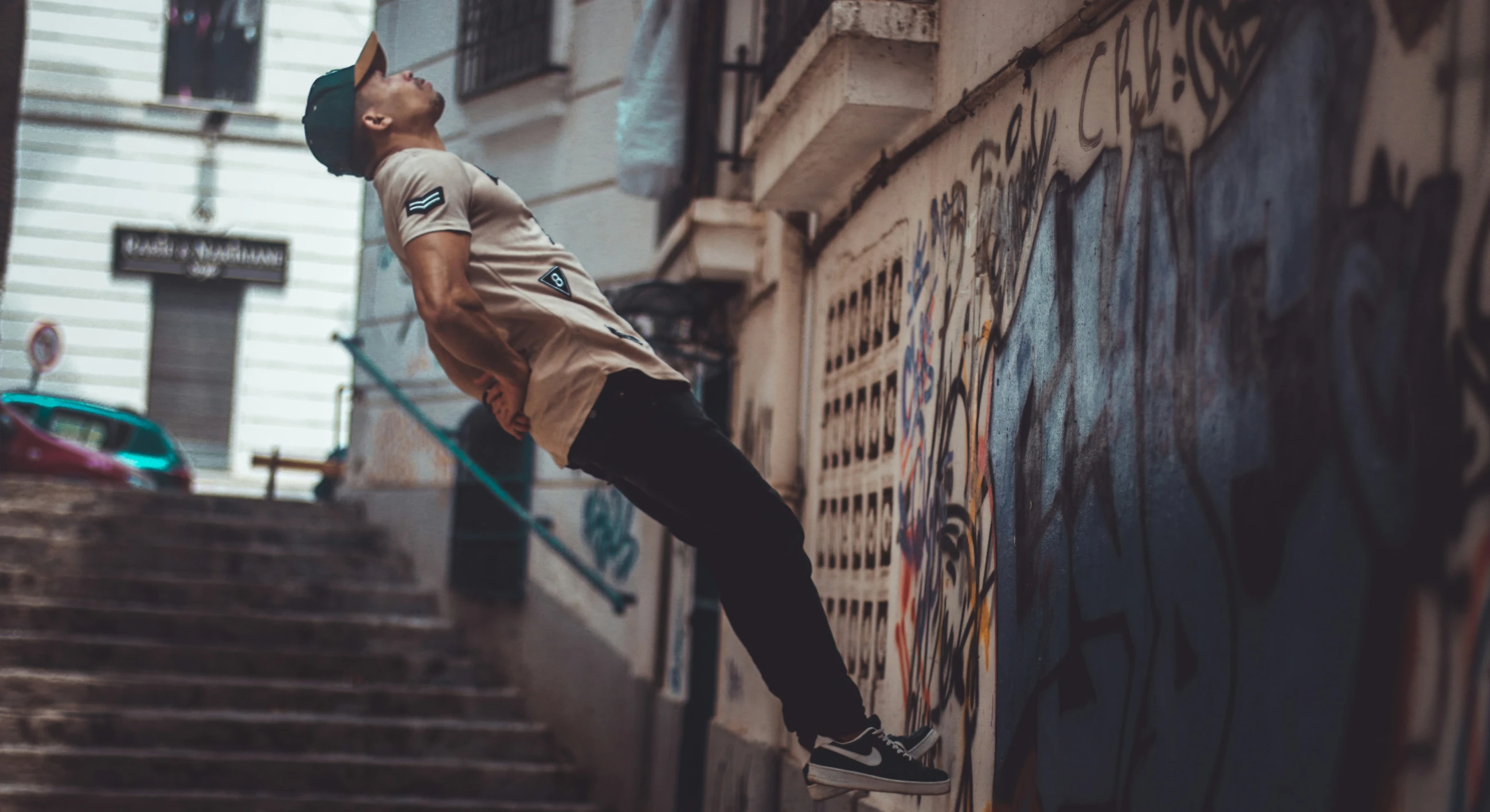 a man with his skateboard in mid air above the stairs