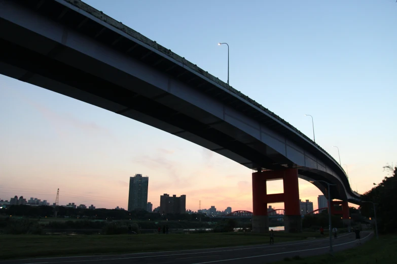 a long road with tall buildings under it