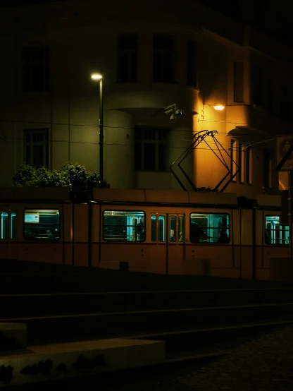 dark night in a train station near many buildings
