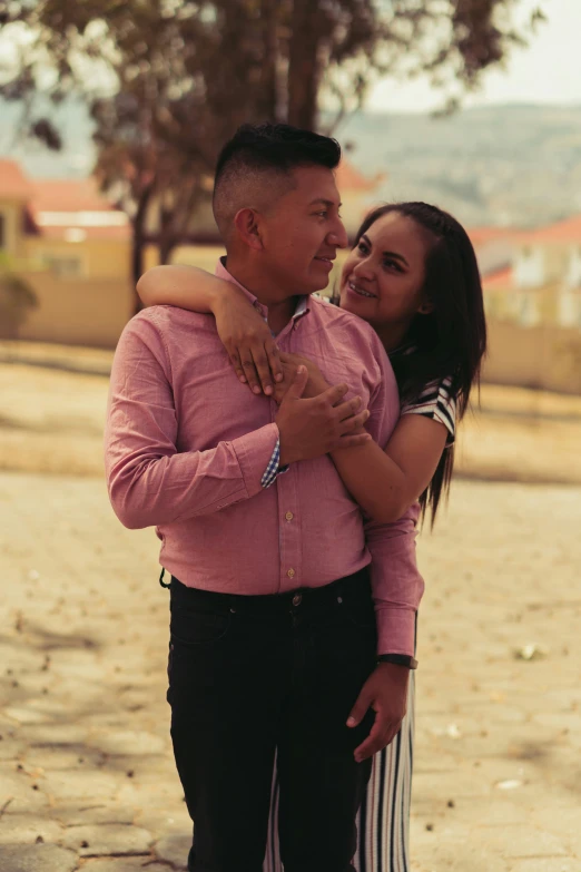 an asian man and woman cuddling in the street