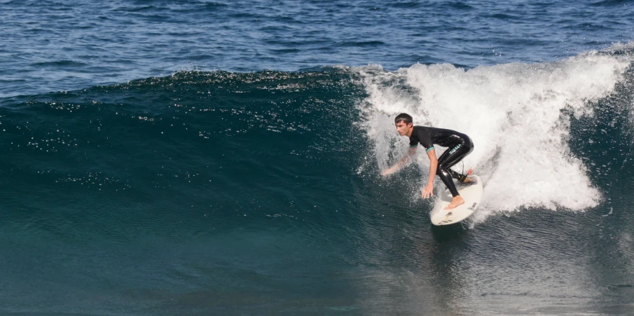 a person riding a wave on top of a surfboard