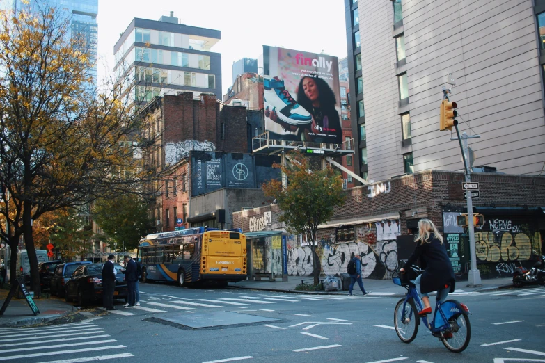 the woman is riding a bike in front of a bus