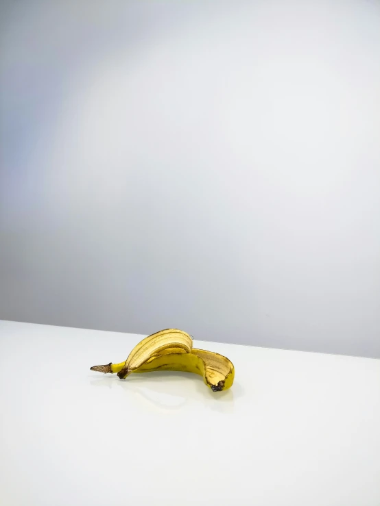 a small banana on a white table